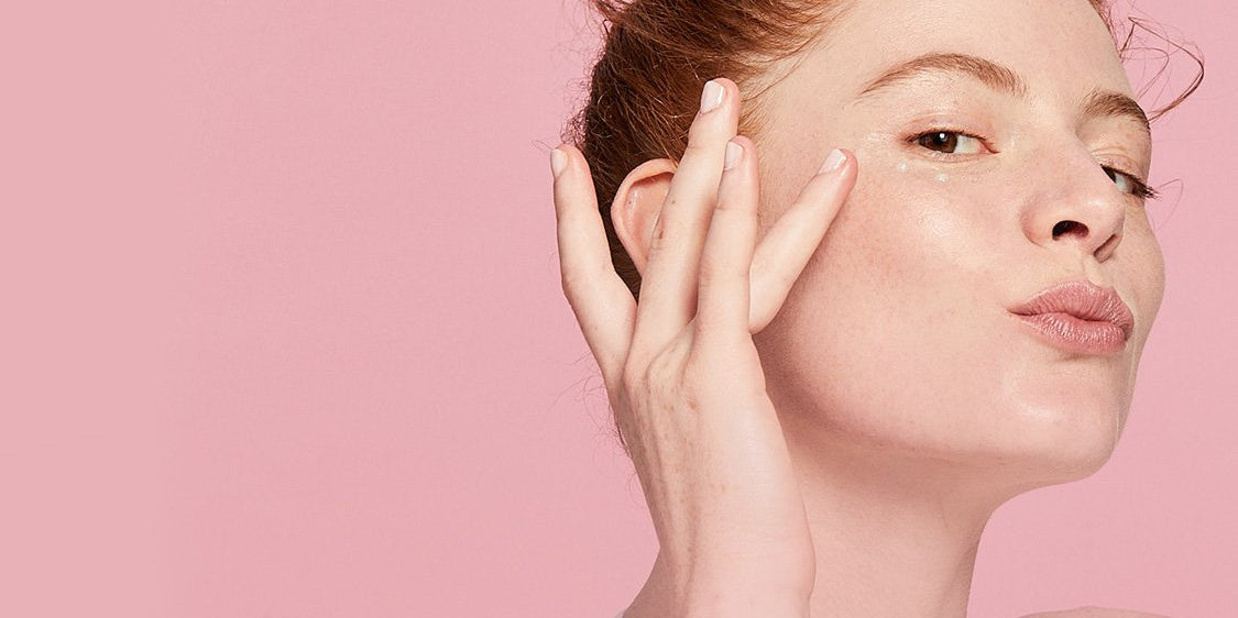 Women tapping her face with finger