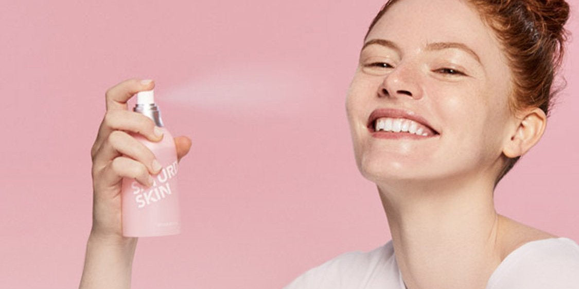 Women spraying a mist on her face