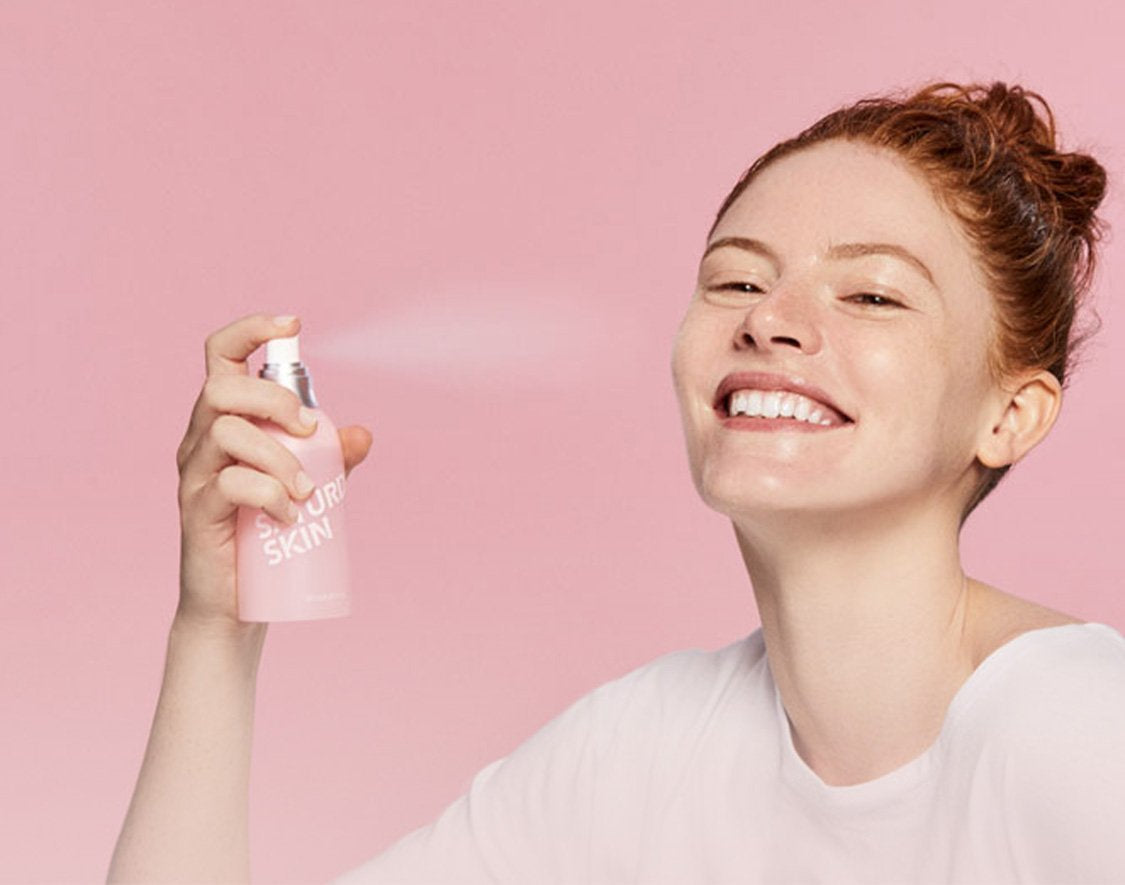 Women spraying a mist on her face